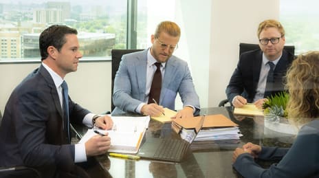 Dunn Sheehan team in a conference
