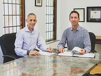 Stuart Mann and Josh Maximon at conference table