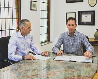 Stuart Mann and Josh Maximon at conference table