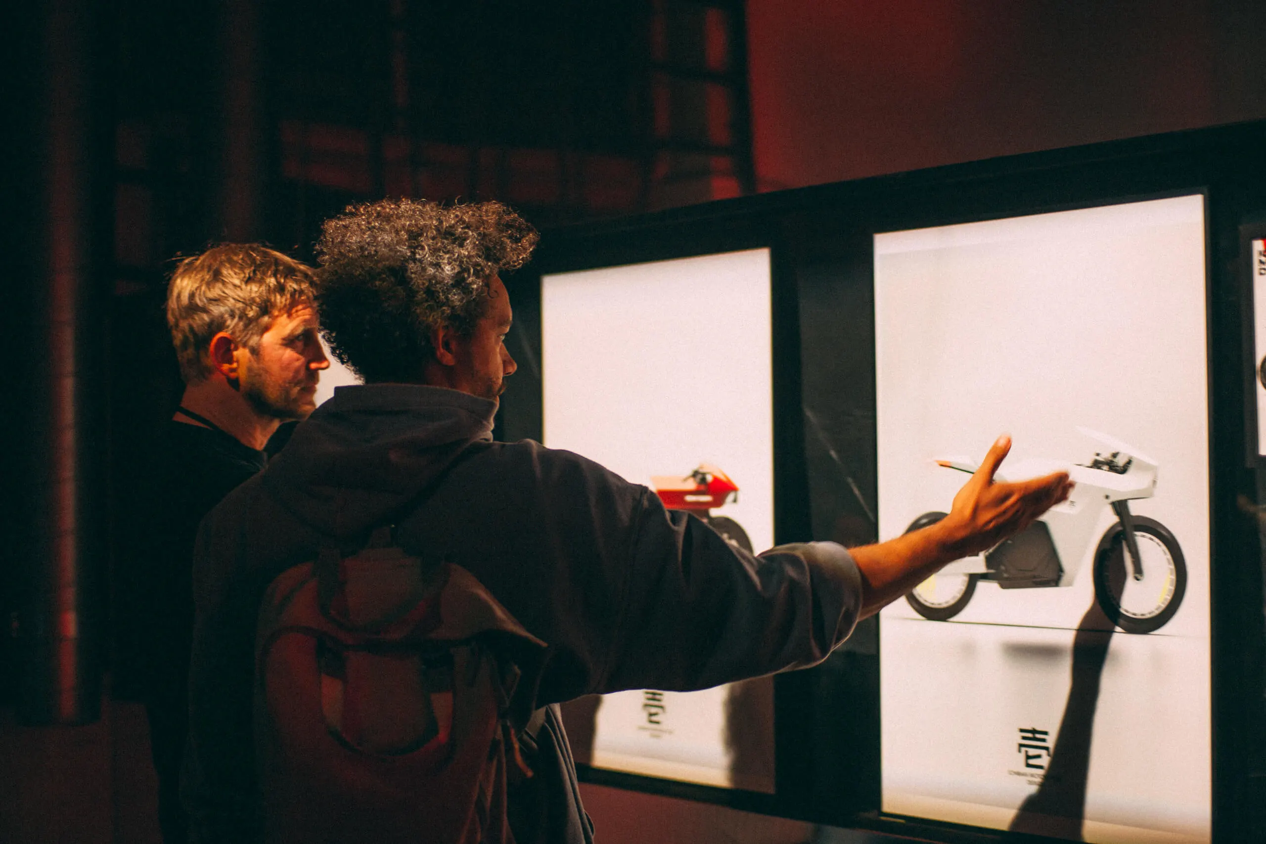 Two people of Ichiban Team showing a sketch of the ichiban moto