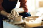 shaping pottery on the wheel Shot