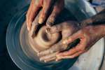 fours hands shaping pottery Shot