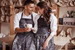 a couple laughing in pottery class Shot