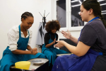 a group of women making pottery Shot