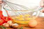 Whisking eggs for Spanish omelette Shot