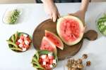 Cutting watermelon for salad Shot