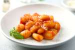 Handmade gnocchi with marinara sauce and basil Shot