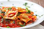 Fresh ravioli with marinara sauce Shot