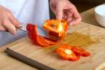 Chicago - chef cutting red bell peppers Shot