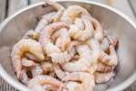 raw peeled shrimp in a metal bowl Shot