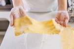 chef's hands holding sheet of fresh pasta dough Shot