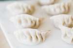 fresh filled dumplings on a cutting board Shot