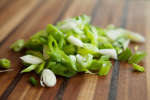 diced green onion on a cutting board Shot