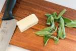 San Diego - butter and fresh sage on a wooden cutting board Shot