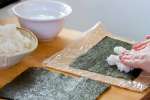 chef laying sushi rice on nori | Classpop Shot