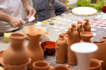 San Diego - people molding clay on outdoor table Shot