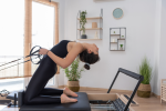 Houston - woman stretching back on reformer Shot