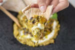 person scooping baba ghanoush with naan bread | Classpop Shot