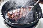 searing a new york strip steak in a cast iron pan | Classpop Shot