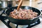 ground beef frying in a cast iron skillet | Classpop Shot