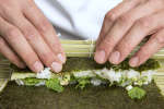 person rolling a sushi roll in a cooking class | Classpop Shot