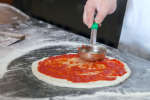 putting tomato sauce on pizza | Classpop Shot