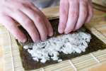a person making maki sushi rolls | Classpop Shot