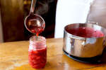 ladeling homemade strawberry jam into a jar | Classpop Shot