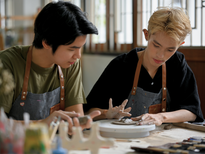 two men hand building clay Shot