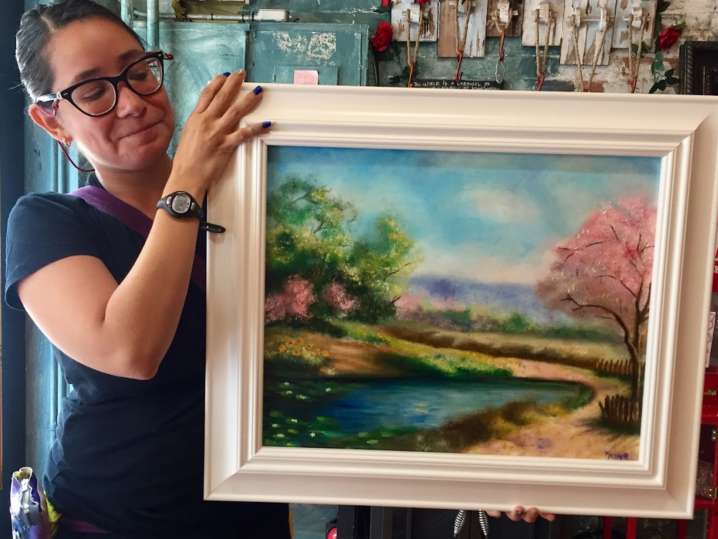 Nashville - woman standing near oil painting Shot