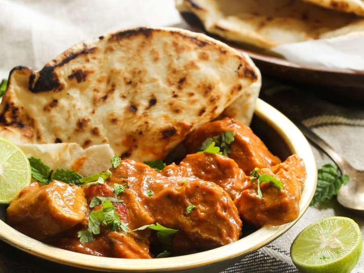 Indian Tikka Masala dish with chicken and naan Shot