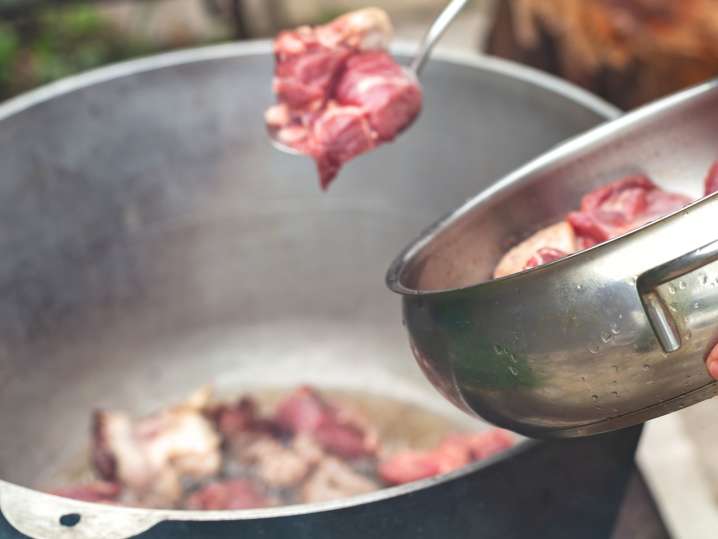 Putting lamb cuts into the stew Shot