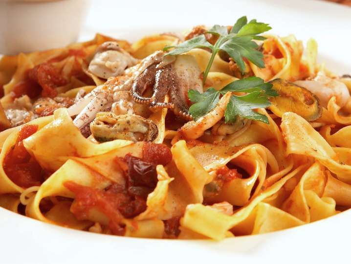 Fresh pasta with marinara sauce sand seafood Shot