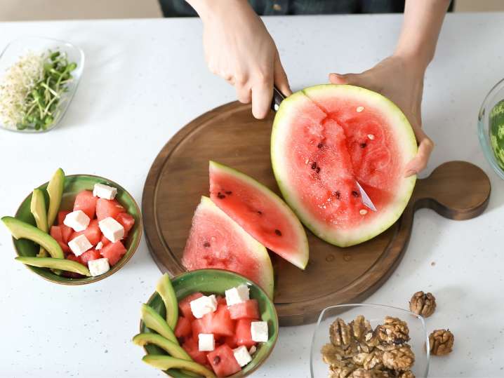 Cutting watermelon for salad Shot