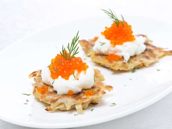 Crisped potatoes with herbs, sour cream and assorted caviar Shot