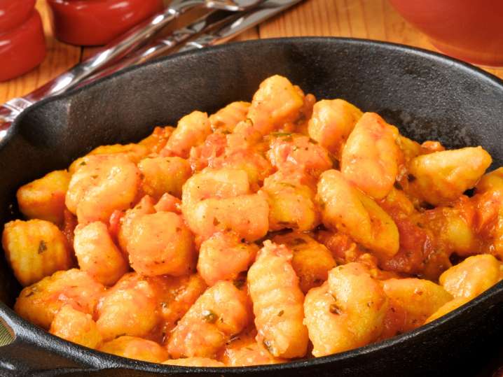 Gnocchi in a pan mixed with tomato sauce Shot