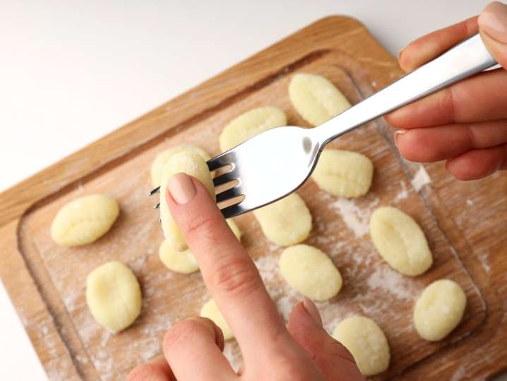 Shaping gnocchi by hand and fork Shot