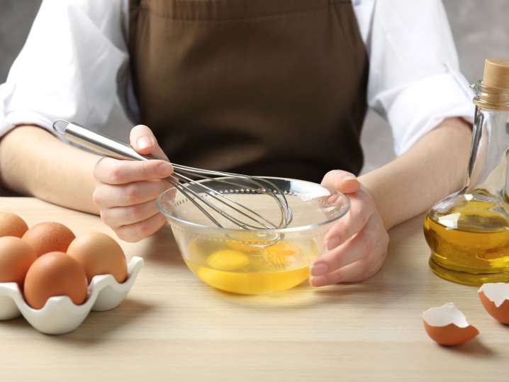 Whisking eggs for the base of carbonara sauce Shot