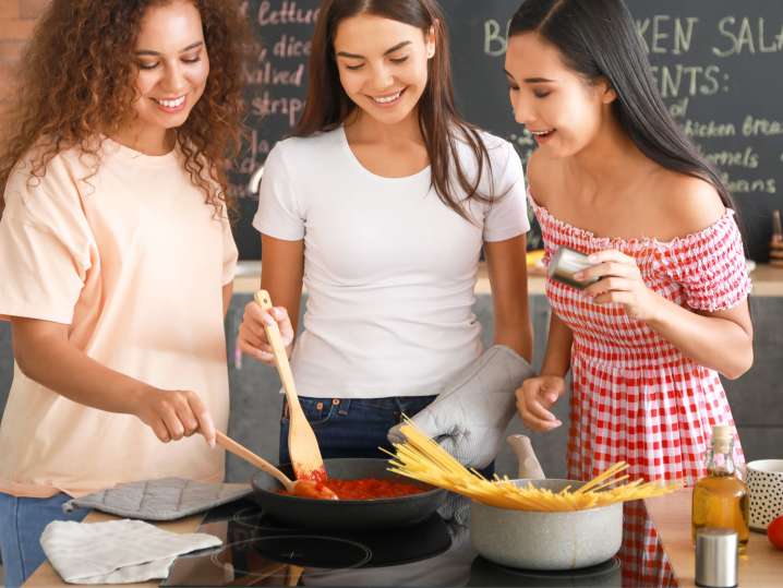 Cooking pasta and marinara sauce together Shot