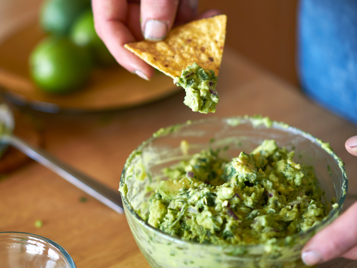 Dipping chips in guacamole Shot