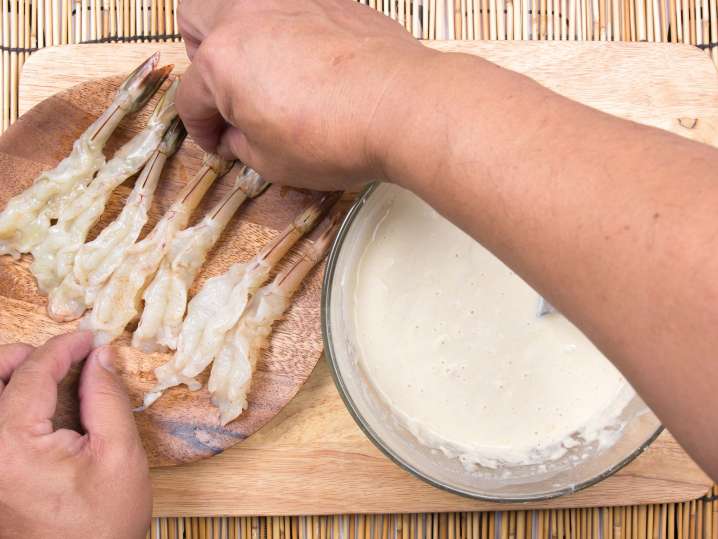 Dipping shrimp into batter Shot