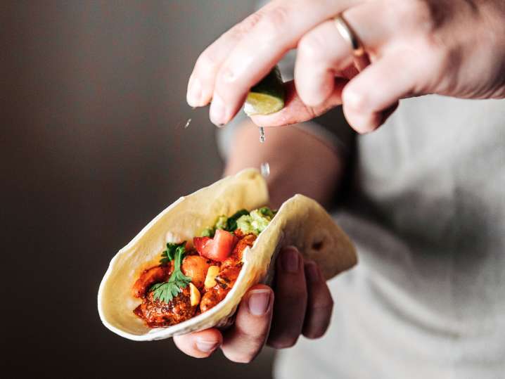 Squeezing lime juice over fresh taco Shot