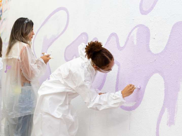 NYC - women painting a wall in team building activity Shot