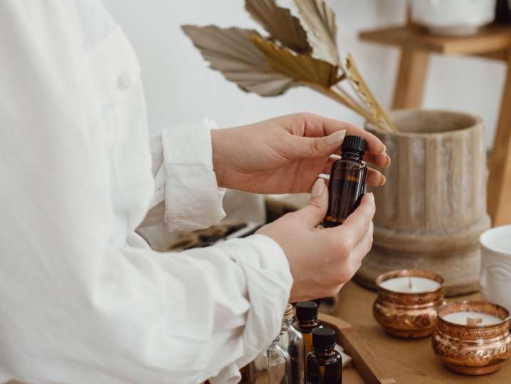 Dallas - Woman Preparing Bottles of Scented Oil for Candle Making Shot