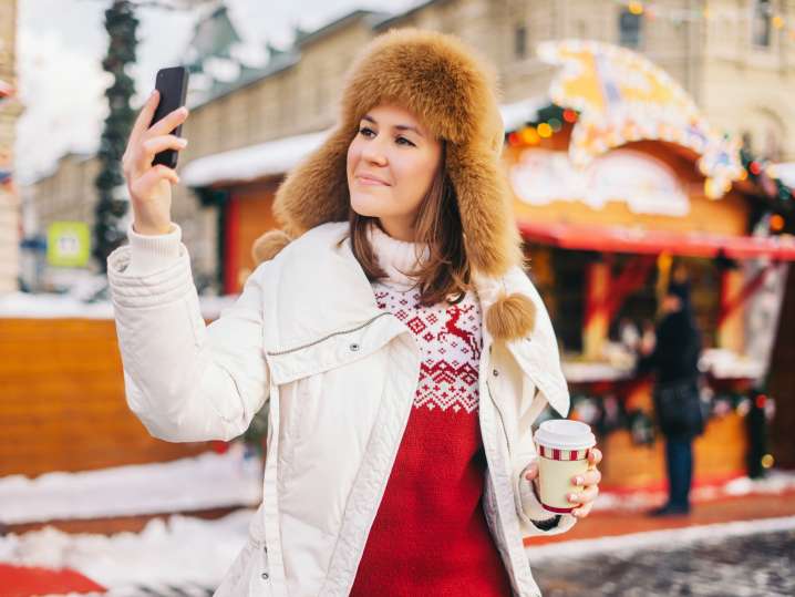 NYC - Woman taking selfie at Christmas market Shot
