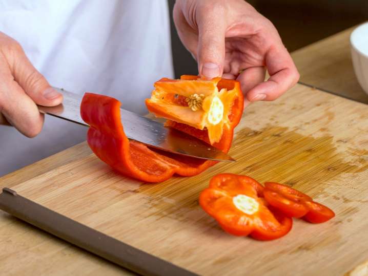 Raleigh - chef cutting red bell peppers Shot