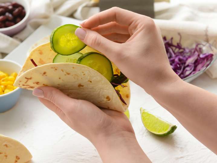 Las Vegas - Woman Making Tasty Taco on Light Background Shot