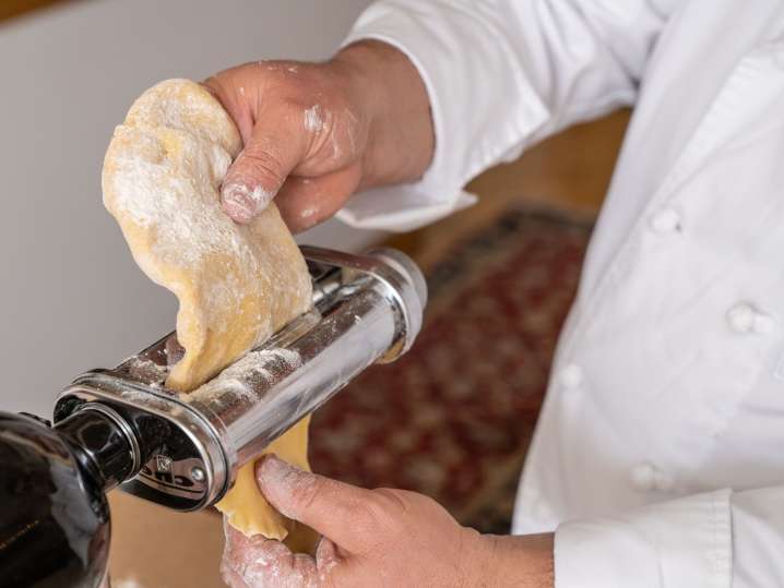 Salt Lake City - Rolling out pasta dough through a pasta machine Shot
