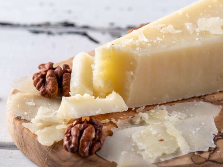 Vancouver - Pecorino romano, hard italian sheep milk cheese on wooden cutting board, selective focus. Copy space Shot