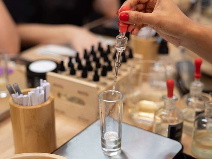 selecting scents and pouring scents in a jar Shot